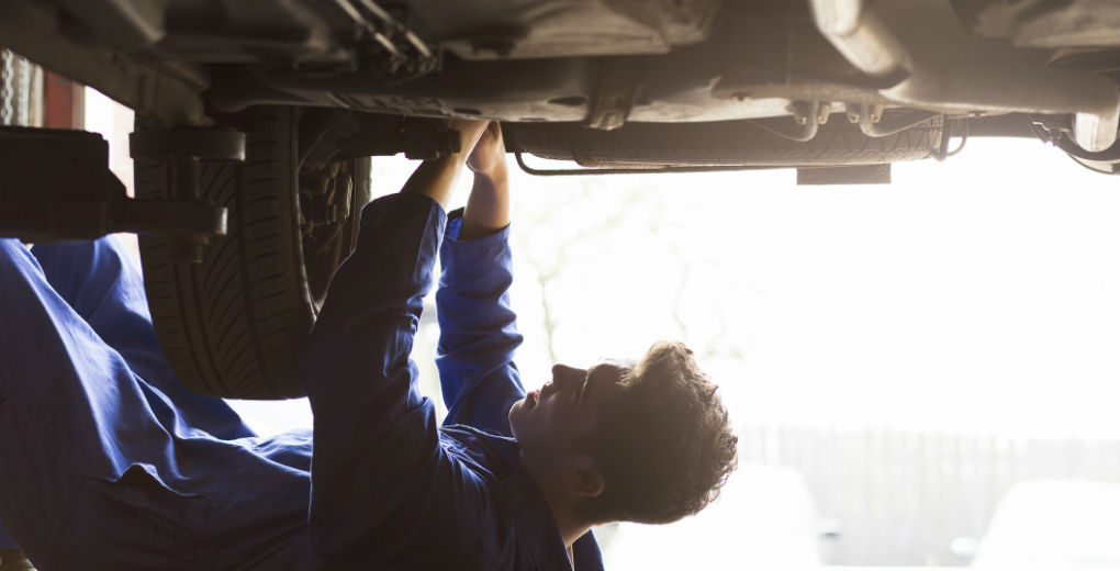 Mechanic fixing car blue jumpsuit